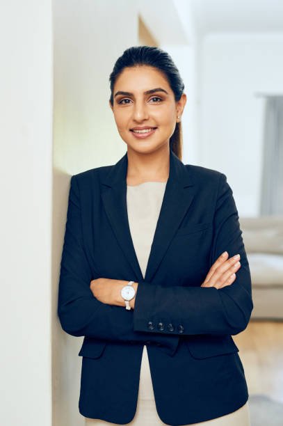 portrait of a young woman standing in an office